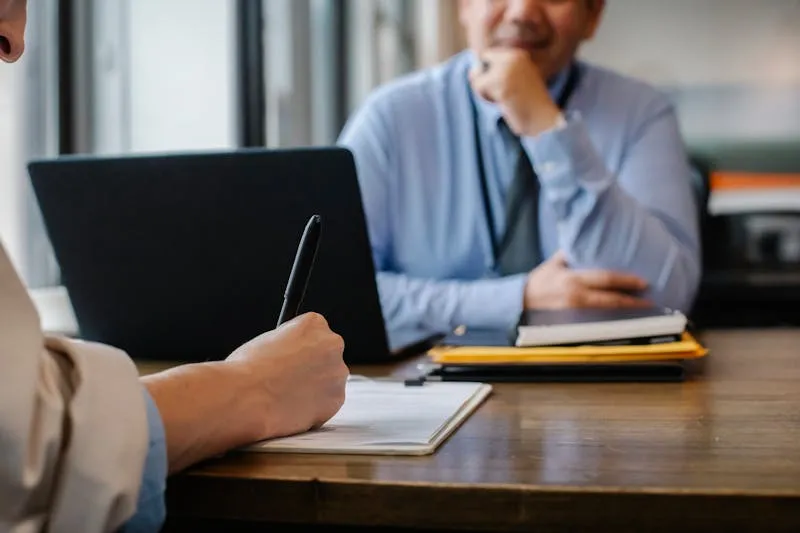 Business owner reviewing safety compliance documents at a laptop
