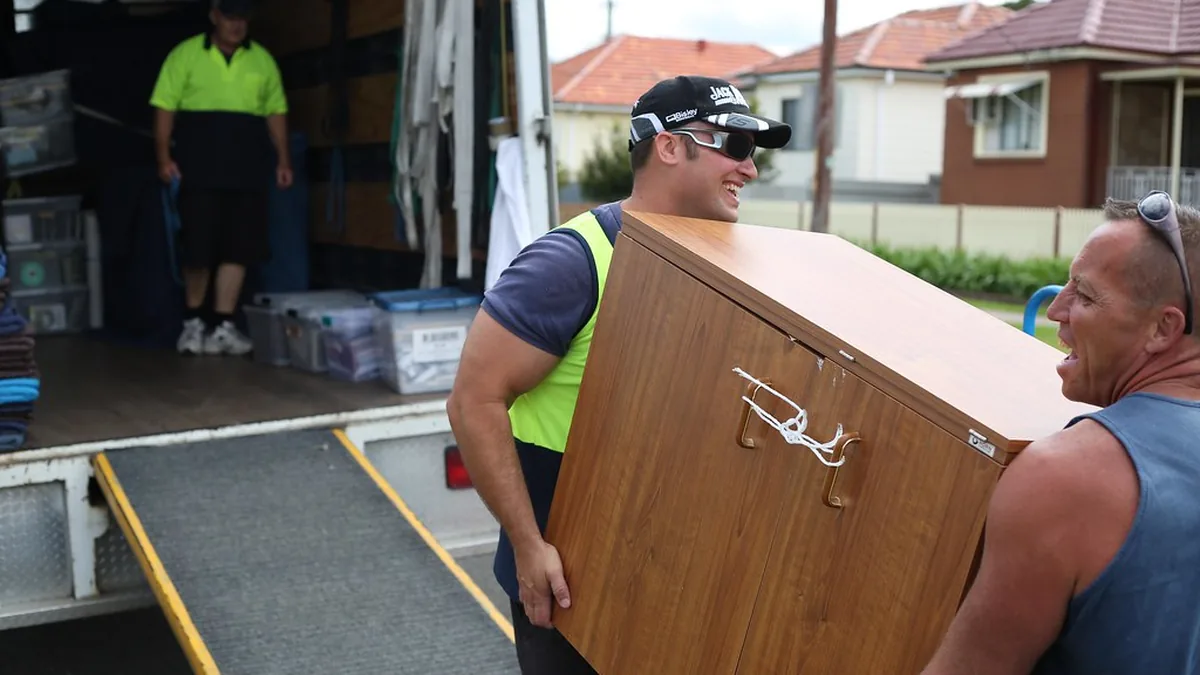 Moving crew loading furniture into a box truck — the kind of experienced help that's getting harder to find in a tight labor market